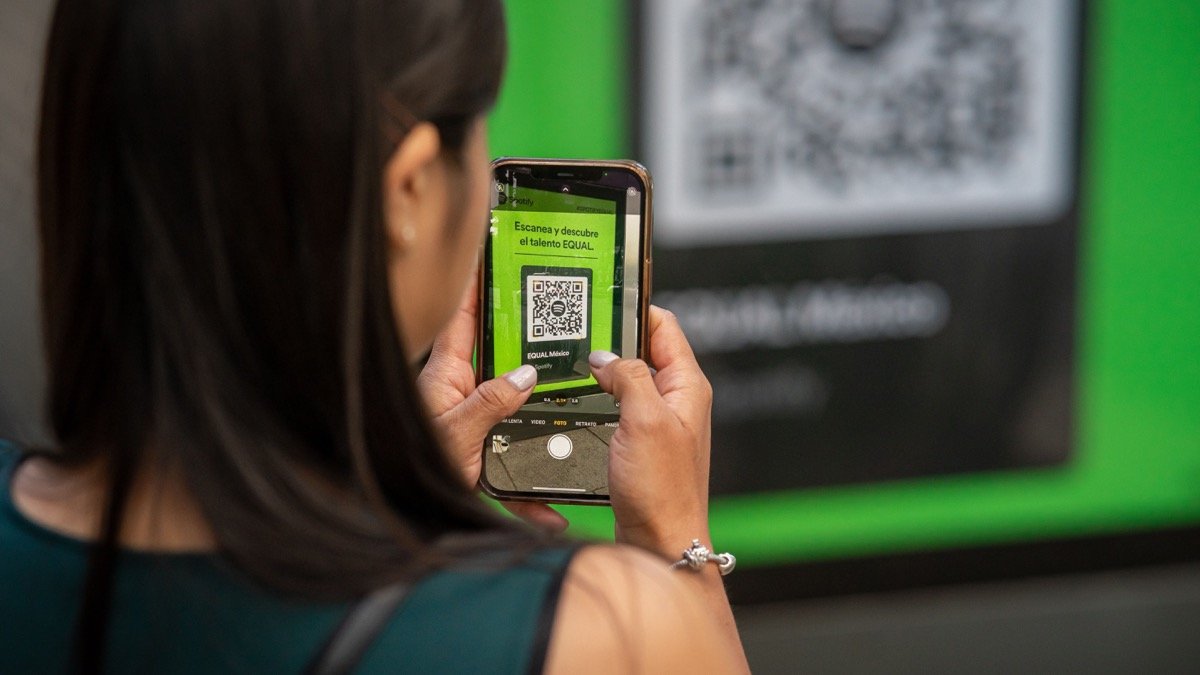 一名女子用手機掃描公共展示上的 QR Code